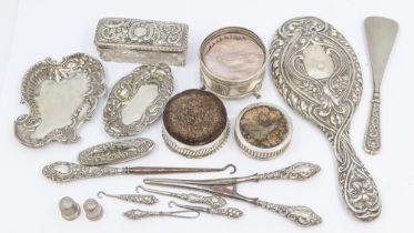 A collection of silver items to include; a Victorian silver cased fabric circular pin cushion,