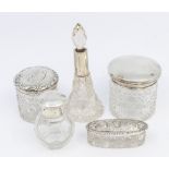 A small collection of mixed silver topped vanity and toilet bottles to include; a Birmingham