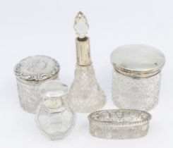 A small collection of mixed silver topped vanity and toilet bottles to include; a Birmingham