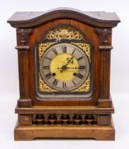 A late 19th/early 20th century wooden bracket clock, gilt metal dial and column supports and with