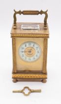 An early 20th Century French gilt metal carriage clock retailed by Lowe & Sons Chester, white enamel