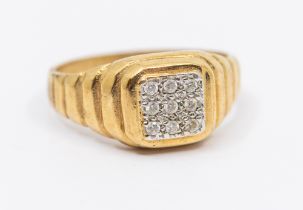 A gents diamond set 9ct gold signet ring, comprising a square top pave set with small round