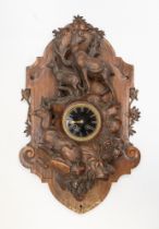 A 19th Century Swiss Black Forest mahogany wall-mounted clock decorated with two standing and one