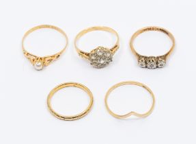 A collection of five 9ct gold rings, to include an illusion set three stone diamond ring, size O1/2,