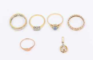 A collection of five gold rings to include a three stone diamond and 18ct gold ring, size M1/2,