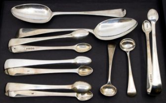 A collection of 19th Century silver flatware to include: four sugar tongs, two Old English Pattern