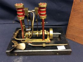 A mid 20th century unmarked horizontal live steam beam engine, in wooden case.