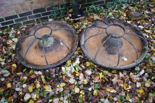 Two cast iron pig feeders.