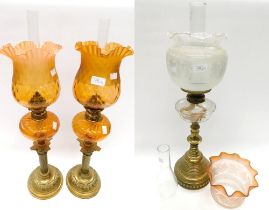 A collection of brass stemmed oil lamps, to include a pair of late Victorian brass stemmed oil lamps