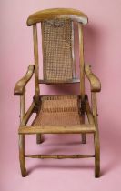 A 19th century bergere and mahogany folding armchair.