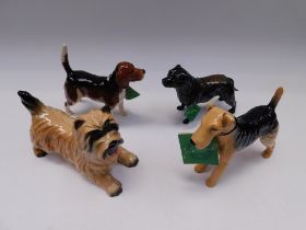 Four boxed Beswick dogs, Terrier, Staffordshire, beagle and Airedale.