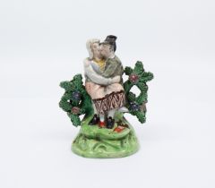 A Staffordshire figure of 'Lovers' seated on a tree stump c.1825, size 12cm high. Condition: man's