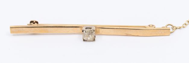 A diamond and 9ct gold bar brooch, platinum claw set to the centre with an old European cut diamond,