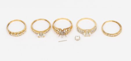 A collection of five cubic zirconia set 14ct gold dress rings, (one missing central stone) sizes