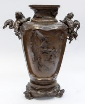 A Japanese Meji period bronze two handled bronze vase, with detachable lion's handled, the body with