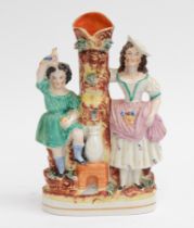 Late 19th century Staffordshire spill vase figures by a well