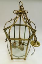 Mid to late 20th C brass ceiling hanging three candle lantern light with six glazed panels.