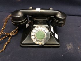 A mid 20th century bakelite telephone with chrome dial (broken handle)