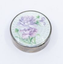 A 20th century silver and guilloche enamelled circular pill box, having lilac floral design to