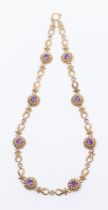 An amethyst and unmarked gold necklace, comprising rope style links inset with round mixed cut