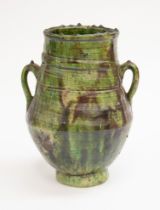 An early 20th century probably Belgian art pottery twin handled vase, of green and brown mottled