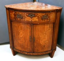 An early 19th century Dutch floor standing bow front corner cupboard with chequer foliage, lady