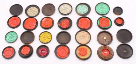 A collection of 19th Century probably Lignum Vitae circular seal boxes and covers, containing hard