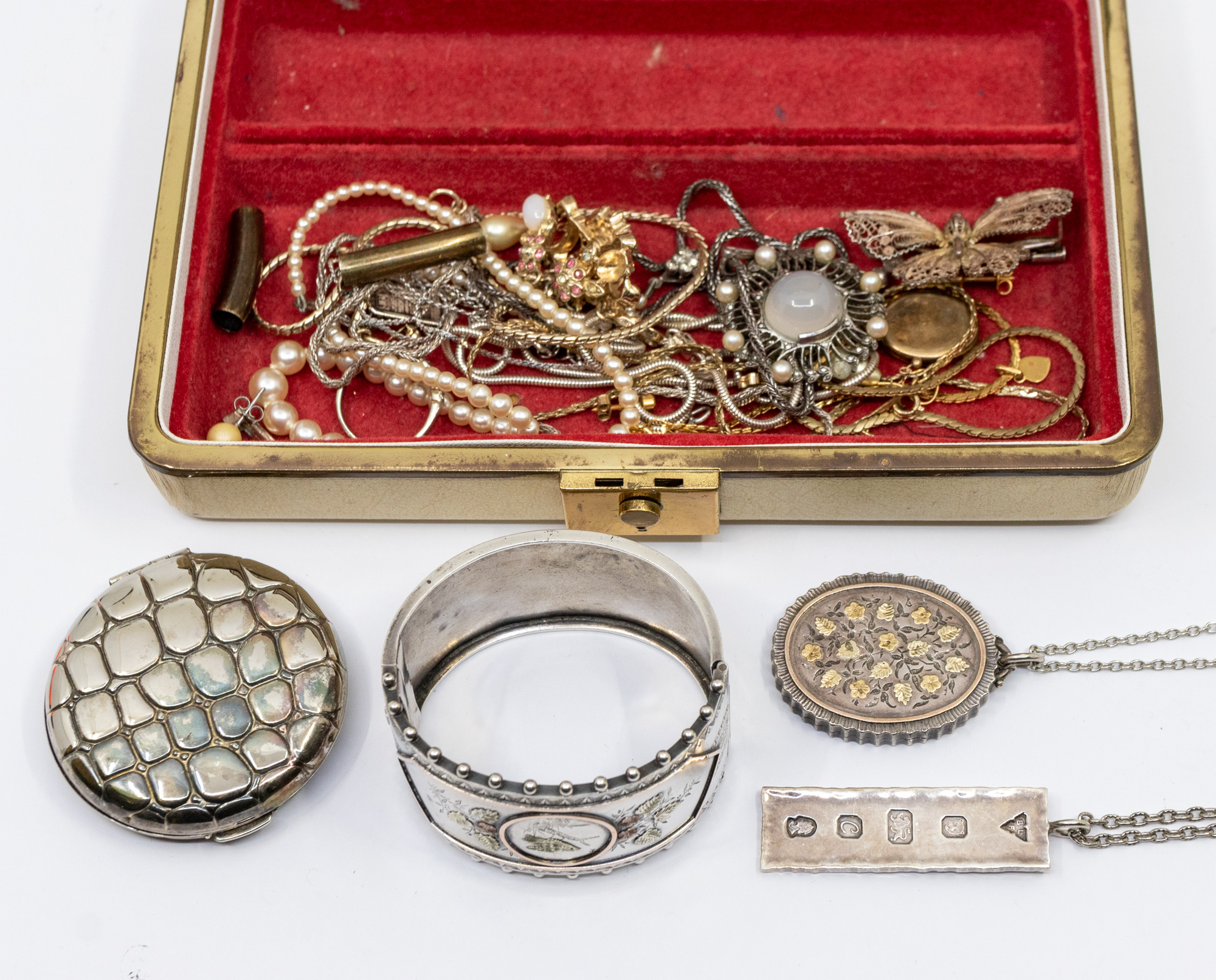 A small collection of costume jewellery to include Victorian silver cuff bangle with applied foliate