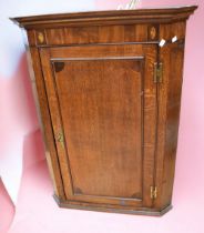 George III large oak wall hanging corner cupboard with inlayed door border.