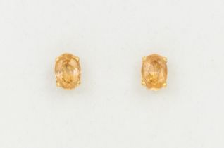 A pair of Imperial topaz and 18ct gold stud earrings, comprising oval mixed cut topaz approx 2.