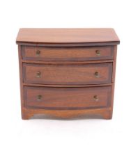 A mahogany doll's house chest of drawers