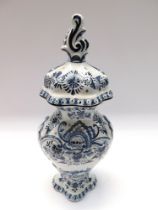A modern 20th century tall Delft pottery vase and cover, in traditional blue and white. Marked to