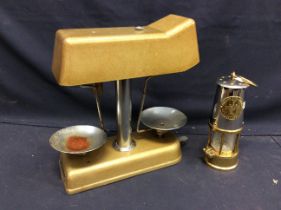A 1960s universal money checker weighing scales along with a Eccles miners lamp.