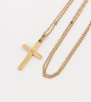 A 9ct gold textured cross, size approx 25mm, suspended from a fine yellow metal chain, length approx