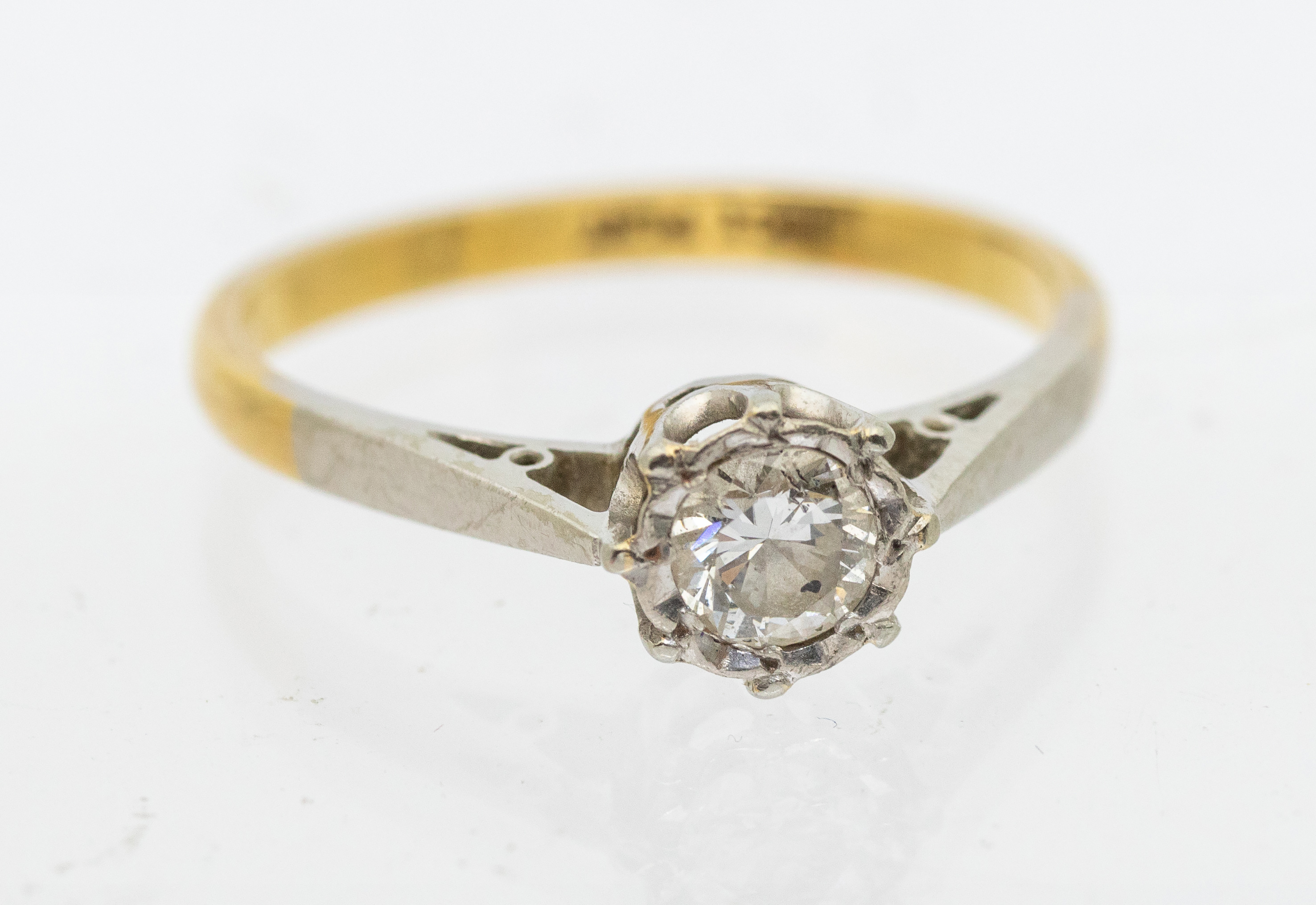 A diamond and 18ct gold solitaire ring, comprising a platinum illusion set round brilliant cut