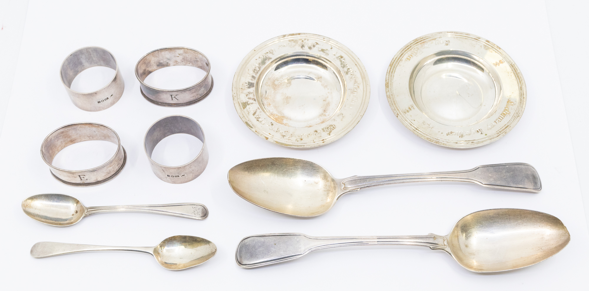 A collection of silver to include; Two similar circular silver pin dishes, each with engraved script