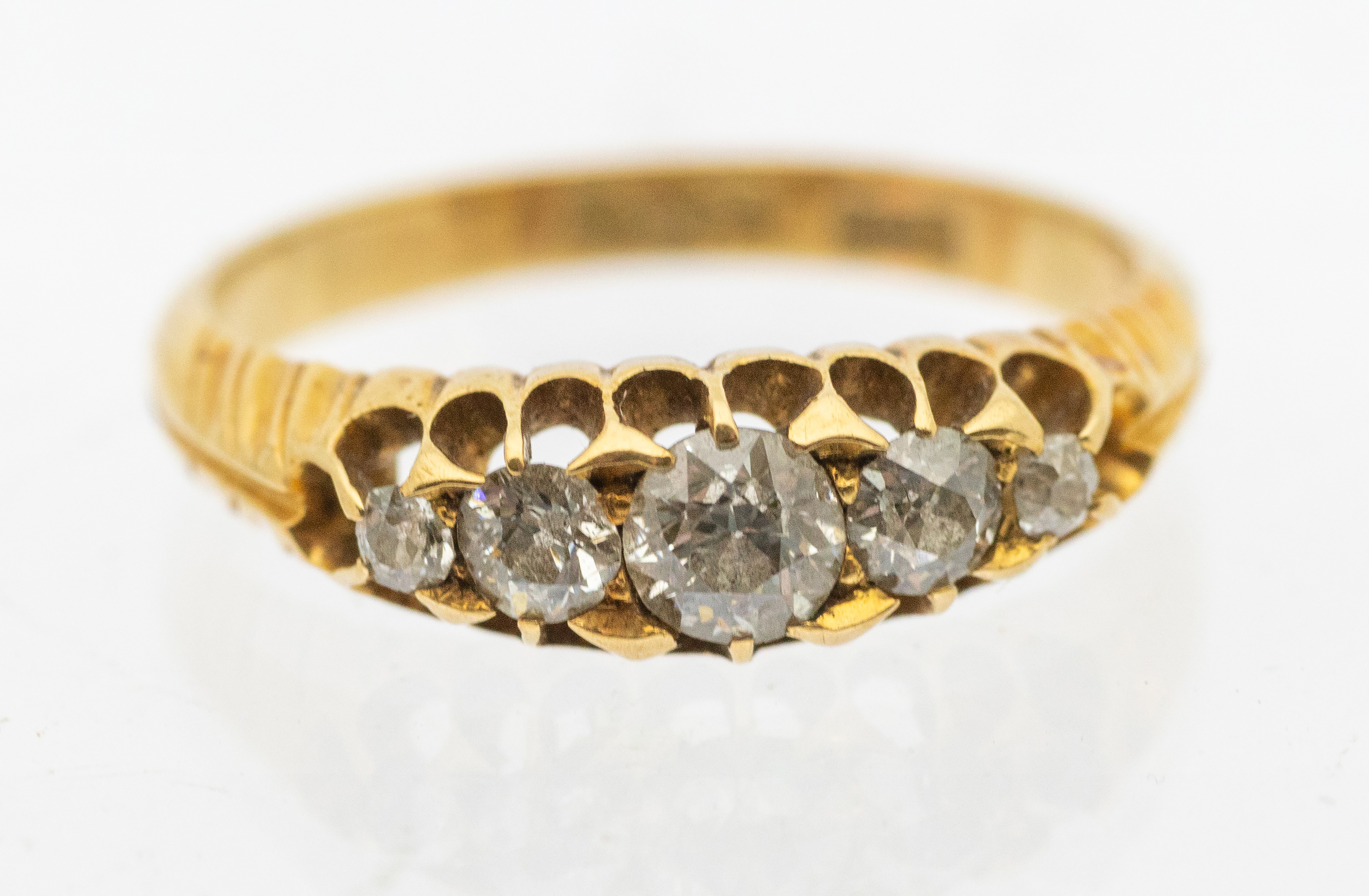 A diamond and 18ct gold boat head ring, comprising a row of graduated old cut diamonds, the centre