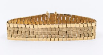 A 9ct gold bracelet, comprising textured brick like links to the centre within a polished link