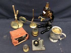 Early 20th century table top microscope brass magnifier glasses on stands, tankard, box, camera