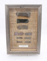 Framed late medieval book clasps in display framed wall hanging case