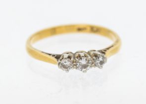 A diamond and 18ct gold three stoner ring, comprising three graduated round brilliant cut