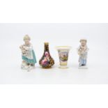 Two small Continental porcelain figures of young ladies, probably German, blue ground with floral