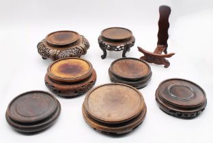 A collection of Chinese hardwood vase and post stands