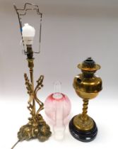 A 19th century brass oil lamp with twisted column and accompanying engraved glass shade and