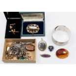 A collection of costume jewellery, comprising a wide engine turned silver cuff bangle, Victorian