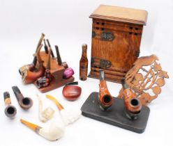 Early 20th century oak smokers cabinet along with a collection of pipe stands and a collection of