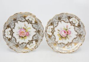 Coalport - Two hand painted floral decorated plates, fluted edged, signed by F. Howard. (2)