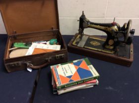 A mixed lot to include a cased Singer sewing machine with instructional handbook, with original