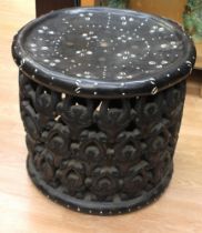 A mid 20th century ebonised African chief's seat inlaid with French francs and shells and with