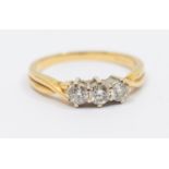 A diamond three stone 18ct gold ring, comprising three round brilliant cut diamonds, total diamond